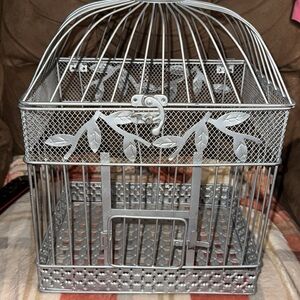 Metal bird cage used for wedding as a card holder